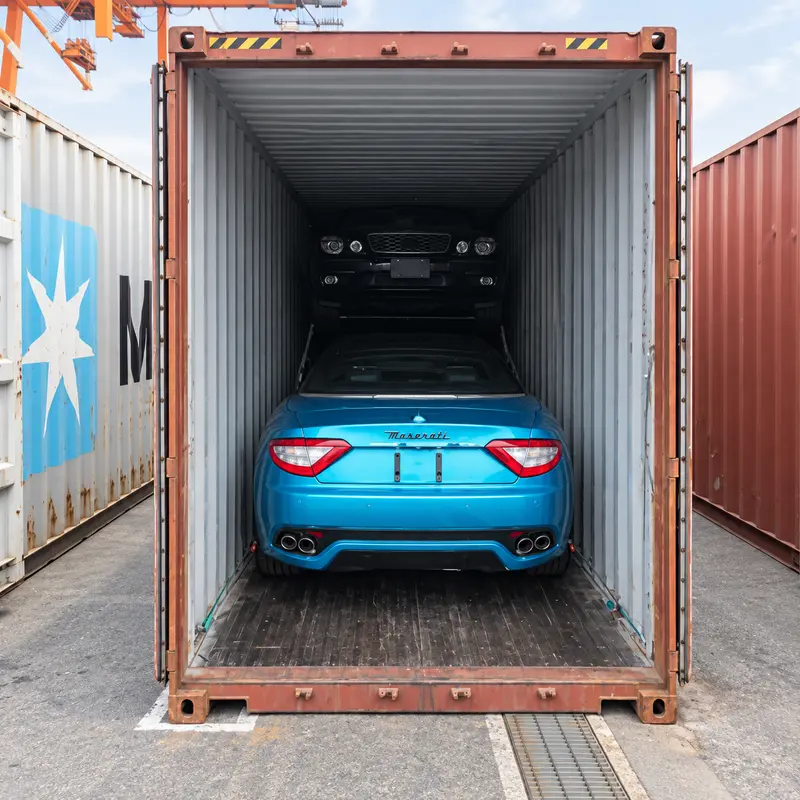 Turquoise Maserati loaded in a shipping container in Japan