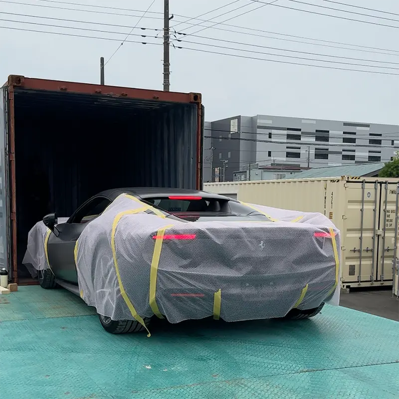 Protected vehicle being loaded into a shipping container in Japan